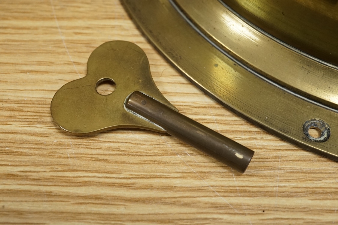H Williamson Ltd, London, brass ships bulkhead timepiece with key, 28cm in diameter